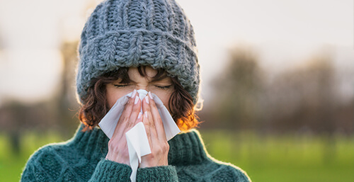 woman sneezing