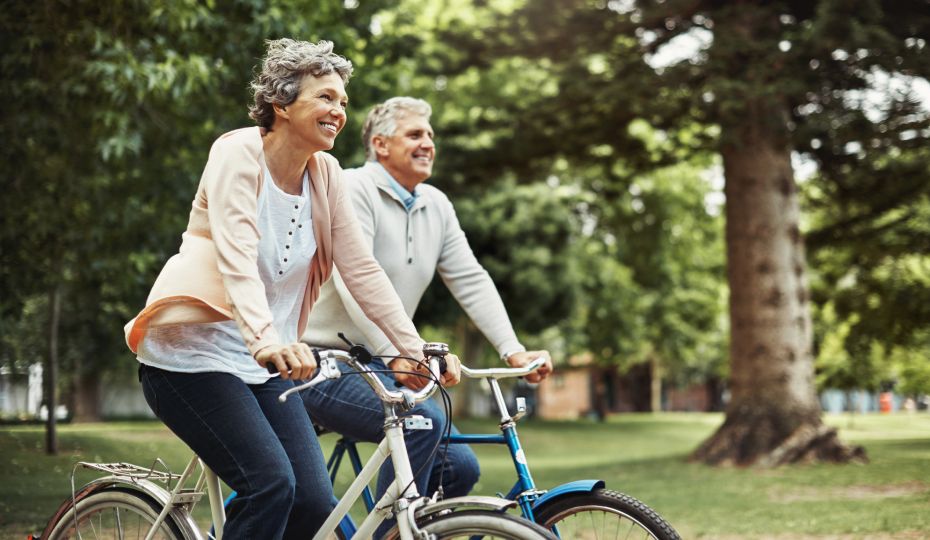 happy couple riding bikes outdoors