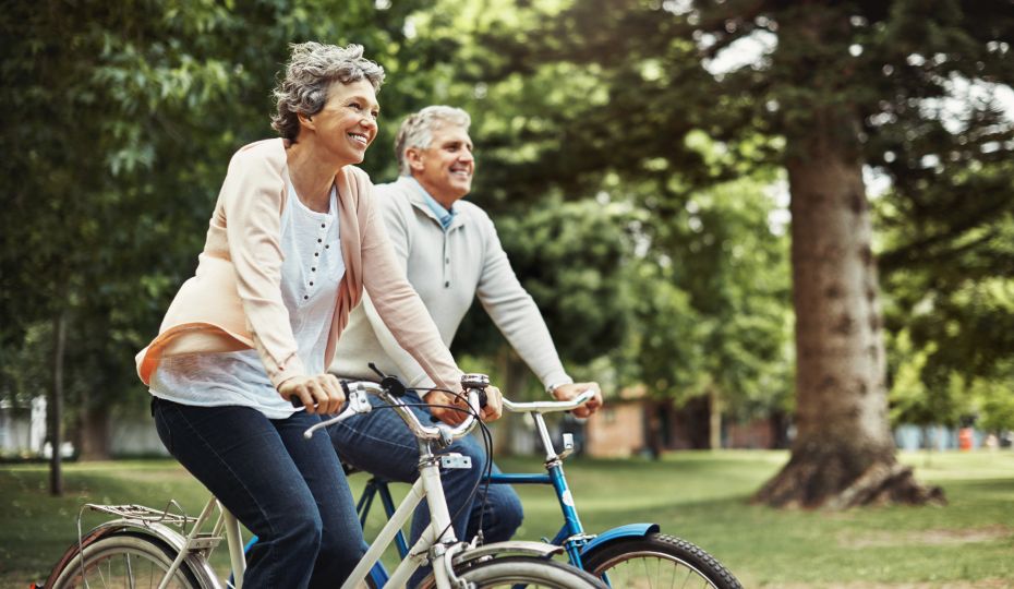 happy couple riding bikes outdoors